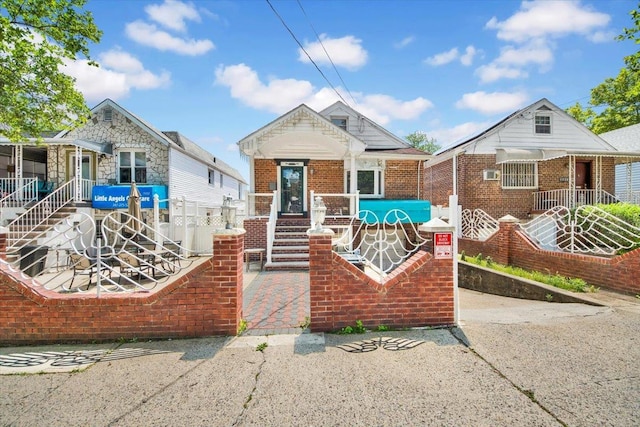 1230 Arnow Ave, Bronx, NY 10469 - view of front of home featuring a porch, stairs, and brick siding
