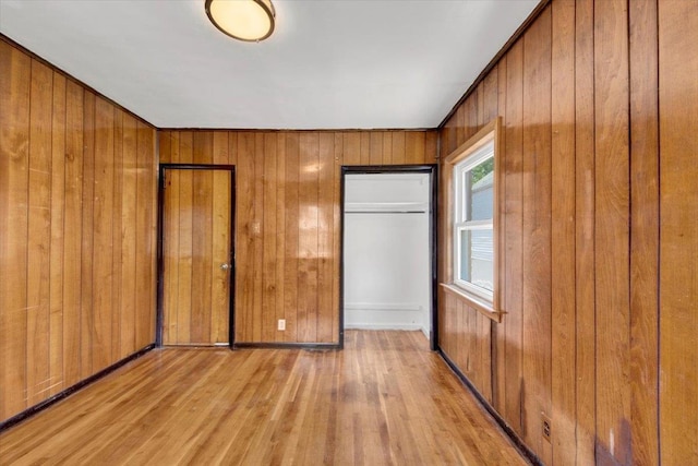 1230 Arnow Ave, Bronx, NY 10469 - unfurnished bedroom with light wood-style flooring and wooden walls
