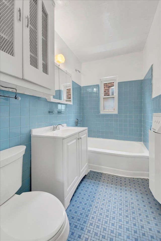 1230 Arnow Ave, Bronx, NY 10469 - bathroom with toilet, tile walls, vanity, a tub, and tile patterned floors