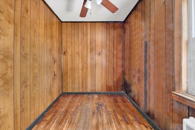 1230 Arnow Ave, Bronx, NY 10469 - empty room with wood finished floors, a ceiling fan, and wood walls