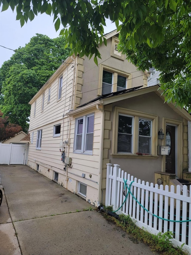view of side of property featuring fence