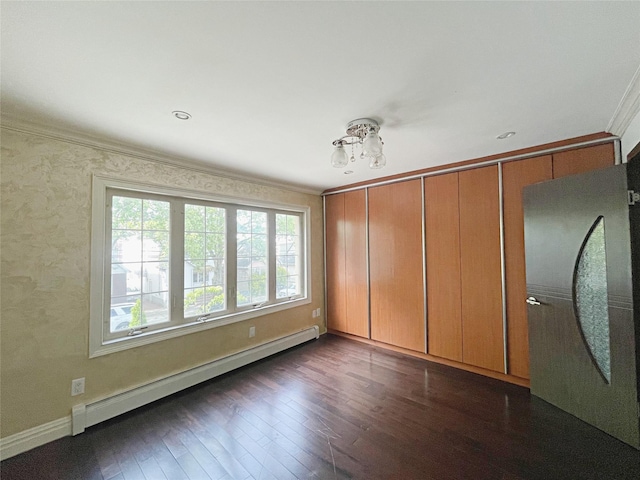 15204 79th Ave, Kew Garden Hills, NY 11367 - spare room featuring a baseboard heating unit, crown molding, dark wood-style flooring, and baseboards