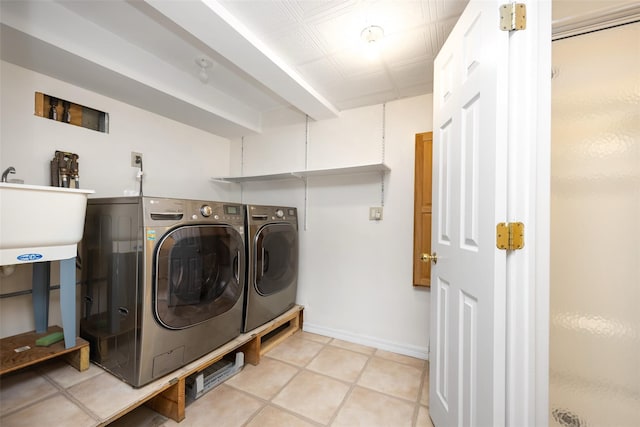 247 Marcus Ave, New Hyde Park, NY 11040 - laundry room with washing machine and dryer, baseboards, and light tile patterned flooring