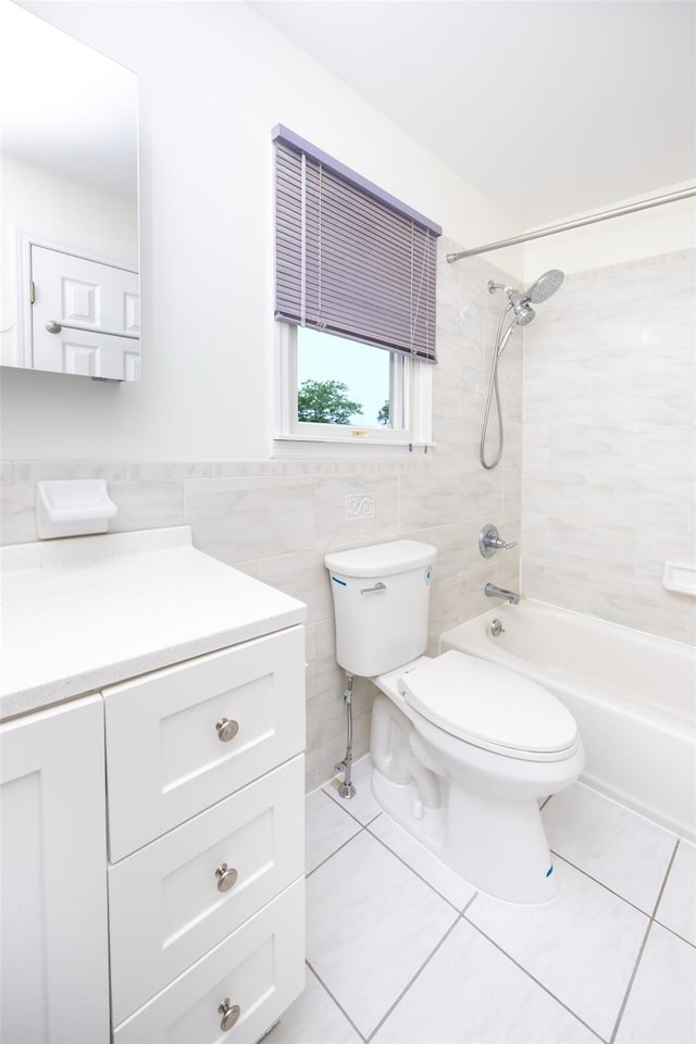 247 Marcus Ave, New Hyde Park, NY 11040 - full bath featuring tile patterned flooring, tile walls, toilet, vanity, and bathtub / shower combination