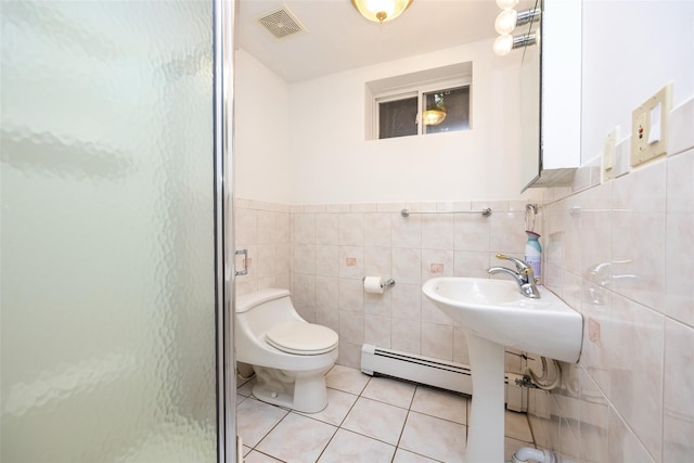 247 Marcus Ave, New Hyde Park, NY 11040 - bathroom featuring a stall shower, tile patterned floors, a baseboard heating unit, tile walls, and toilet