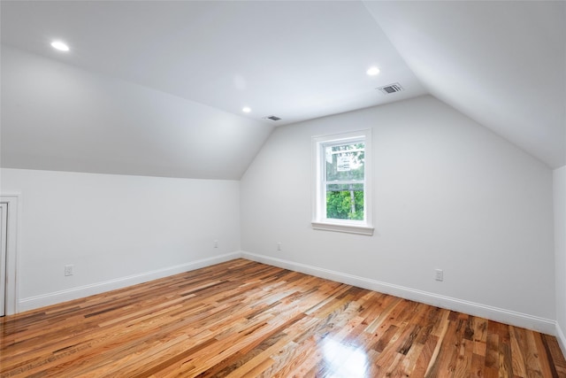 381 Wading River Rd, Manorville, NY 11949 - additional living space with lofted ceiling, baseboards, wood finished floors, and recessed lighting