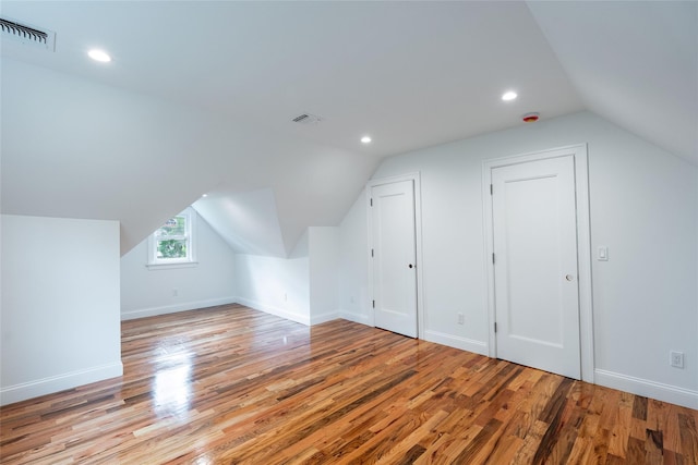 381 Wading River Rd, Manorville, NY 11949 - additional living space with light wood-type flooring, lofted ceiling, baseboards, and recessed lighting