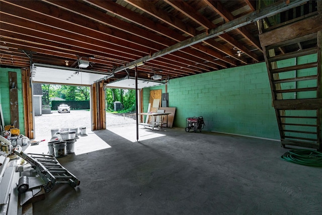 381 Wading River Rd, Manorville, NY 11949 - garage featuring a garage door opener and concrete block wall
