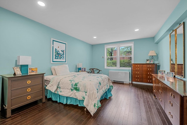 1390 Broadway Unit 107, Hewlett, NY 11557 - bedroom featuring radiator heating unit and dark wood-style floors