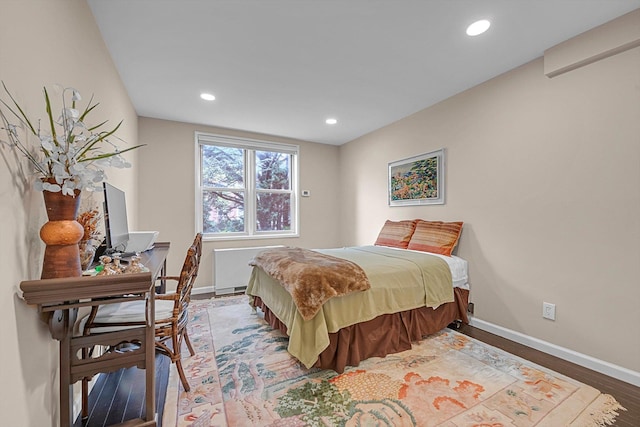 1390 Broadway Unit 107, Hewlett, NY 11557 - bedroom featuring radiator heating unit, baseboards, wood finished floors, and recessed lighting