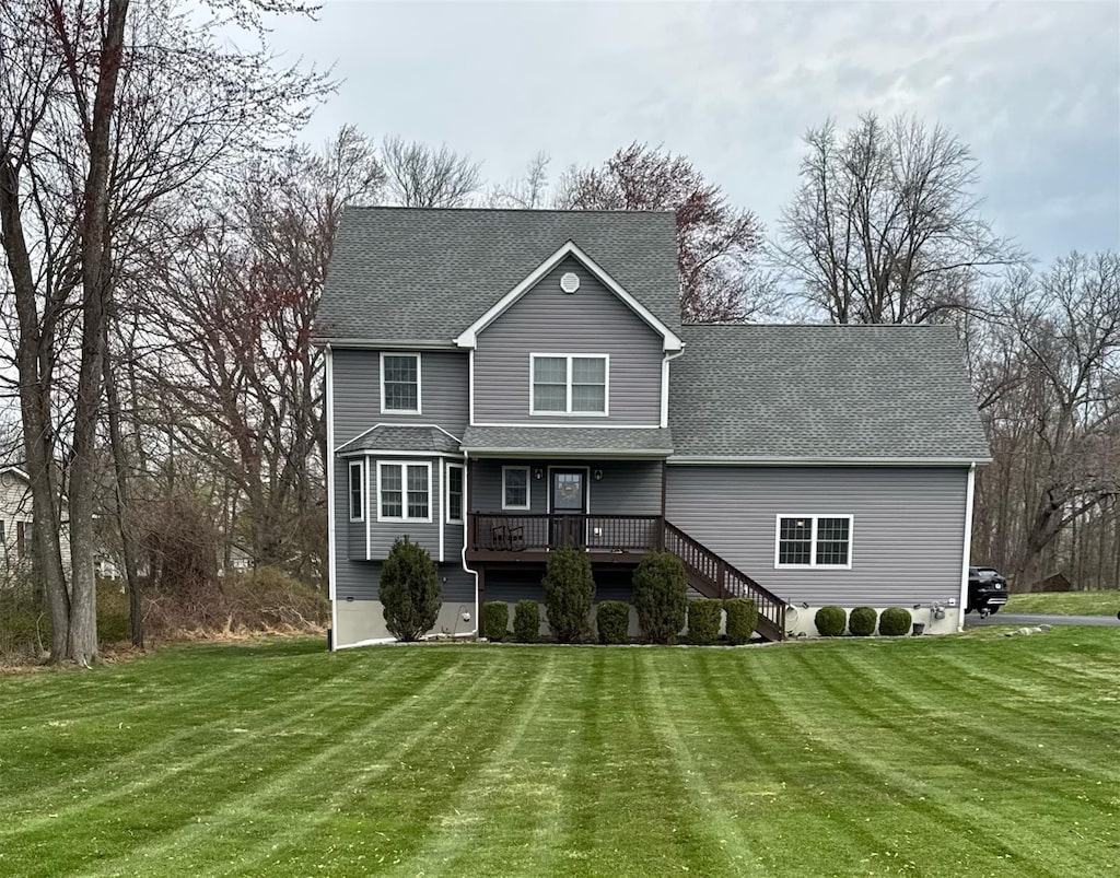128 Beaver Dam Rd, Montgomery, NY 12549 - view of front of home featuring a front yard, a shingled roof, stairs, and a wooden deck