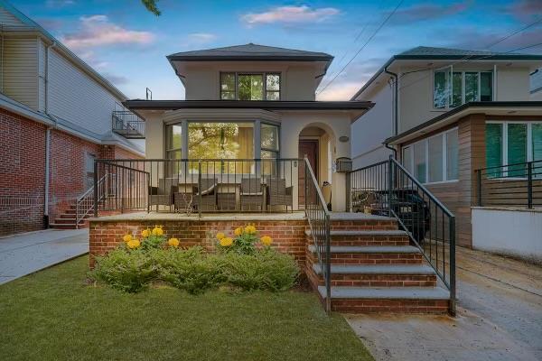 view of front of house with stairs and stucco siding
