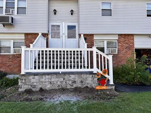 5-7 Barbara Ln, Farmingdale, NY 11735 - view of exterior entry with brick siding and cooling unit