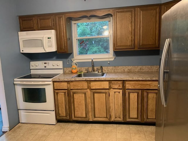 5-7 Barbara Ln, Farmingdale, NY 11735 - kitchen with white appliances, a sink, brown cabinetry, and light tile patterned flooring