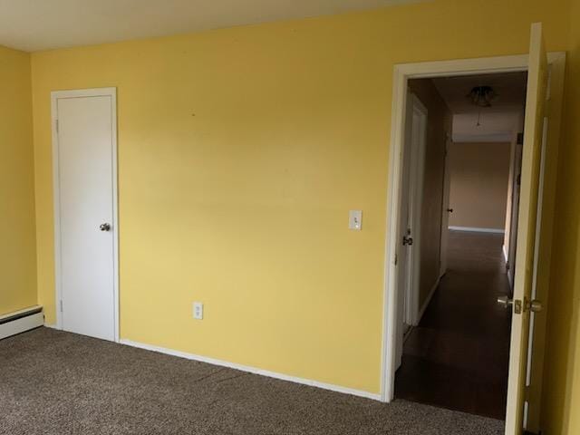 5-7 Barbara Ln, Farmingdale, NY 11735 - carpeted empty room with a baseboard heating unit and baseboards