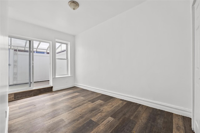unfurnished room featuring wood finished floors and baseboards