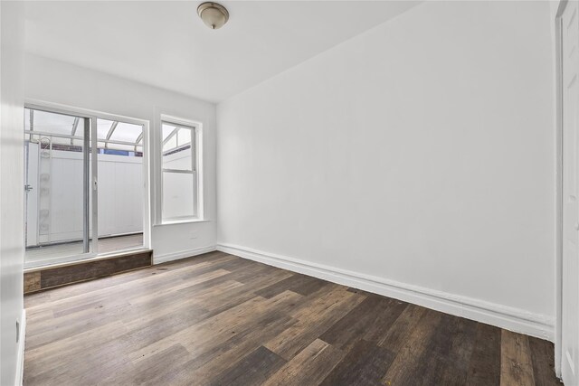 unfurnished room featuring wood finished floors and baseboards