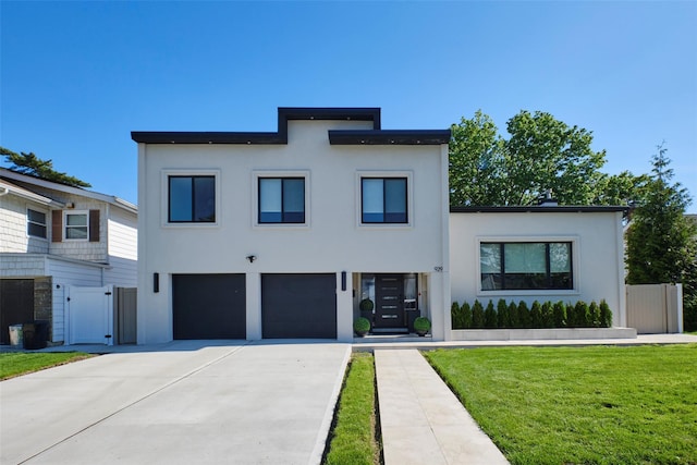 929 Jewel Dr, North Woodmere, NY 11581 - modern home featuring a garage, stucco siding, and driveway