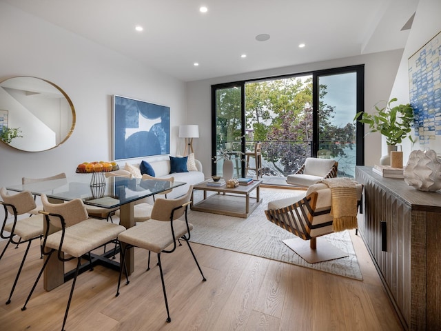 dining area featuring light wood finished floors and recessed lighting