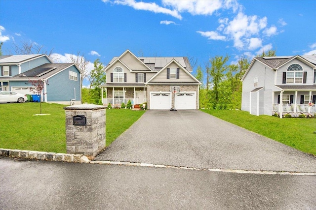 26 Kyleigh Way, Middletown, NY 10940 - traditional-style house with covered porch, roof mounted solar panels, driveway, a front yard, and brick siding