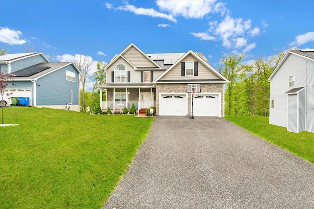 26 Kyleigh Way, Middletown, NY 10940 - view of front of house with covered porch, asphalt driveway, roof mounted solar panels, and a front lawn