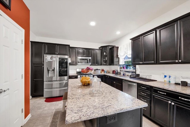26 Kyleigh Way, Middletown, NY 10940 - kitchen with appliances with stainless steel finishes, dark cabinetry, light stone countertops, a center island, and recessed lighting