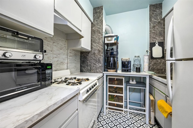 6115 97th St Unit 3R, Rego Park, NY 11374 - kitchen featuring white appliances, decorative backsplash, white cabinets, and under cabinet range hood