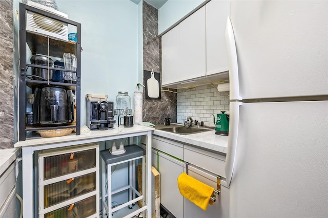 6115 97th St Unit 3R, Rego Park, NY 11374 - kitchen with freestanding refrigerator, backsplash, a sink, white cabinets, and beverage cooler