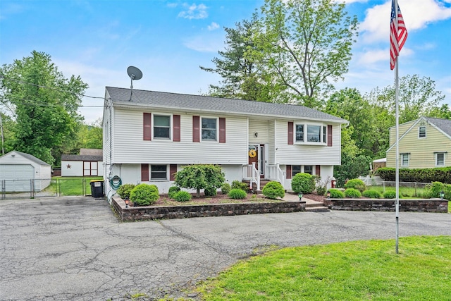 149 E Main St, Washingtonville, NY 10992 - raised ranch with driveway, an outdoor structure, and a detached garage