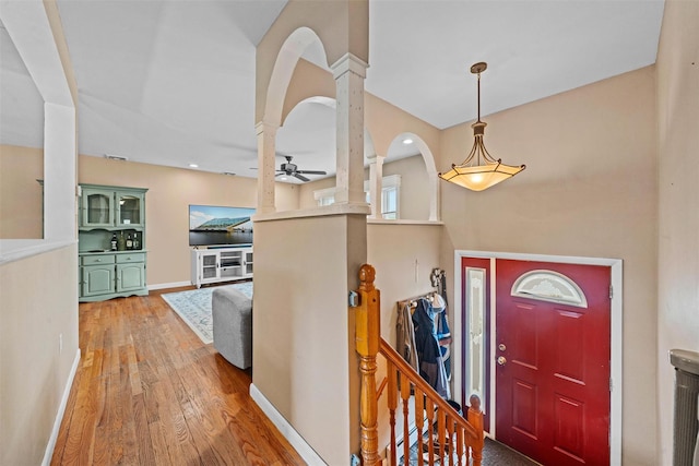 149 E Main St, Washingtonville, NY 10992 - entrance foyer with a ceiling fan, decorative columns, hardwood / wood-style floors, baseboards, and arched walkways