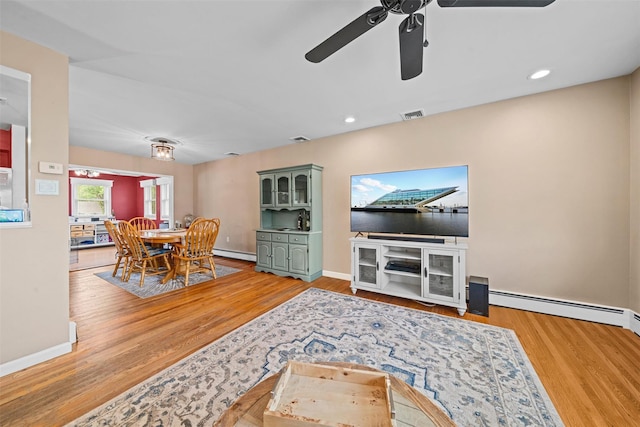 149 E Main St, Washingtonville, NY 10992 - living area featuring baseboards, wood finished floors, a ceiling fan, a baseboard heating unit, and recessed lighting