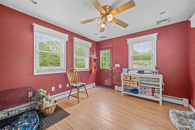 149 E Main St, Washingtonville, NY 10992 - sitting room featuring baseboard heating, a ceiling fan, baseboards, and light wood finished floors