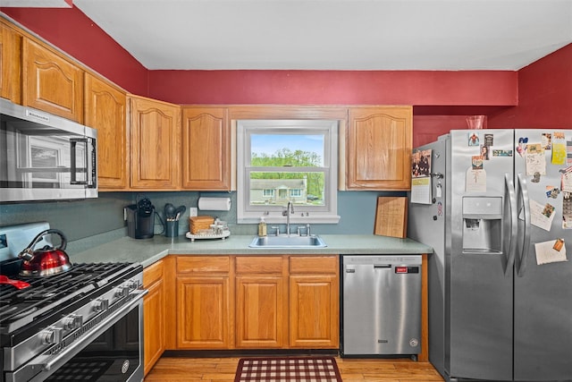 149 E Main St, Washingtonville, NY 10992 - kitchen with stainless steel appliances, a sink, light wood-style flooring, and light countertops