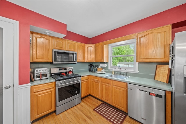 149 E Main St, Washingtonville, NY 10992 - kitchen with stainless steel appliances, a sink, light wood finished floors, lofted ceiling, and light countertops