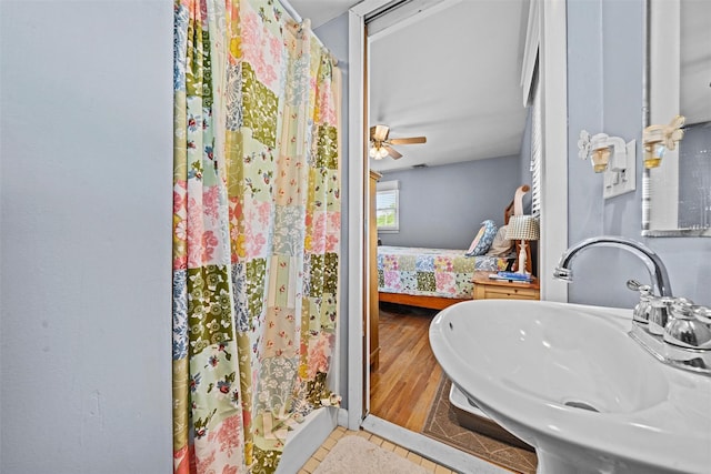 149 E Main St, Washingtonville, NY 10992 - ensuite bathroom featuring a sink, tile patterned flooring, curtained shower, and a ceiling fan