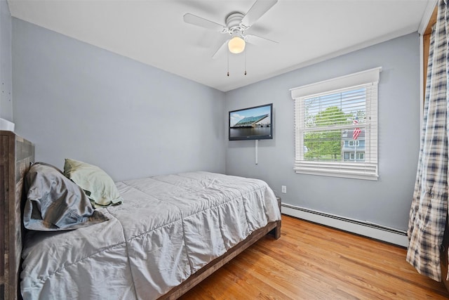 149 E Main St, Washingtonville, NY 10992 - bedroom with a baseboard heating unit, wood finished floors, and ceiling fan