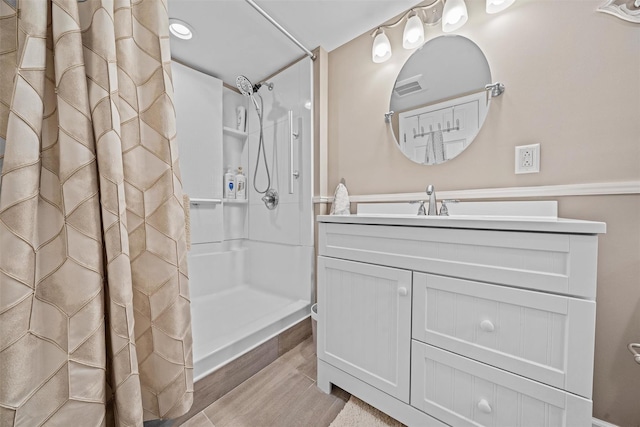 149 E Main St, Washingtonville, NY 10992 - full bathroom featuring wood finished floors, a shower with curtain, and vanity