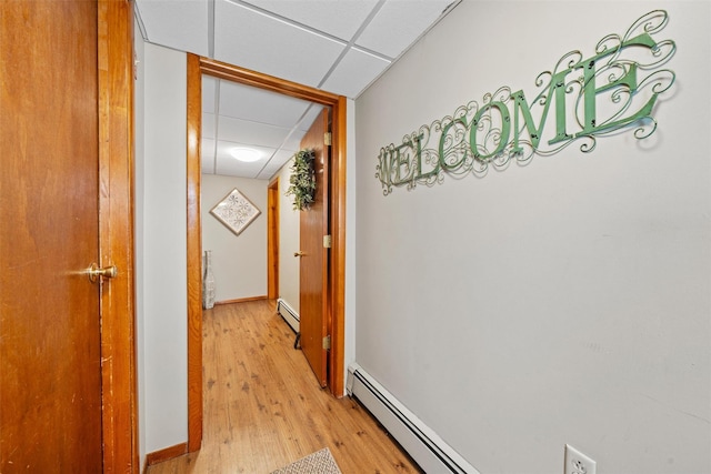 149 E Main St, Washingtonville, NY 10992 - hallway with a drop ceiling, a baseboard heating unit, light wood finished floors, and baseboards