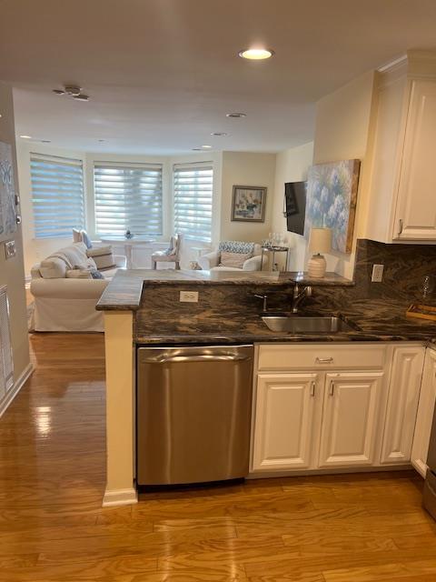 1105 Round Pointe Dr, Haverstraw, NY 10927 - kitchen featuring open floor plan, dishwasher, light wood-style flooring, a peninsula, and white cabinets