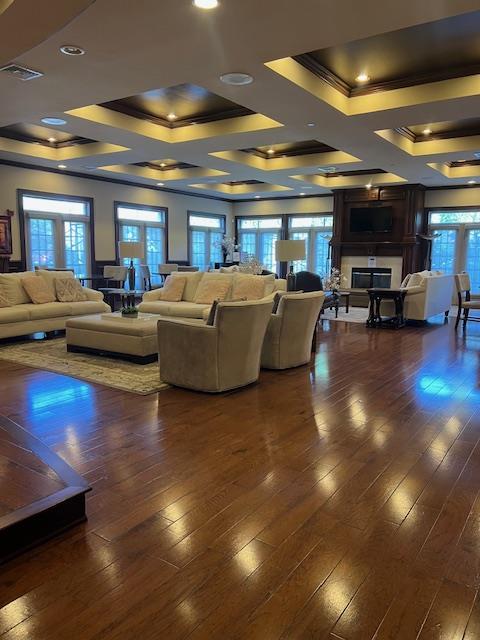 1105 Round Pointe Dr, Haverstraw, NY 10927 - living room featuring ornamental molding, a tray ceiling, hardwood / wood-style flooring, coffered ceiling, and a fireplace