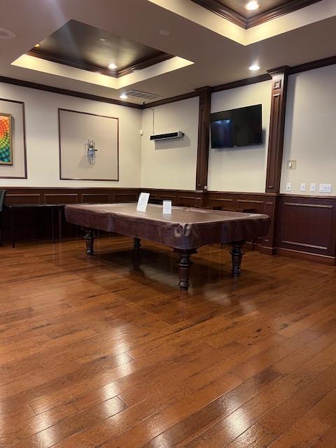1105 Round Pointe Dr, Haverstraw, NY 10927 - recreation room with crown molding, a tray ceiling, wood-type flooring, wainscoting, and a decorative wall