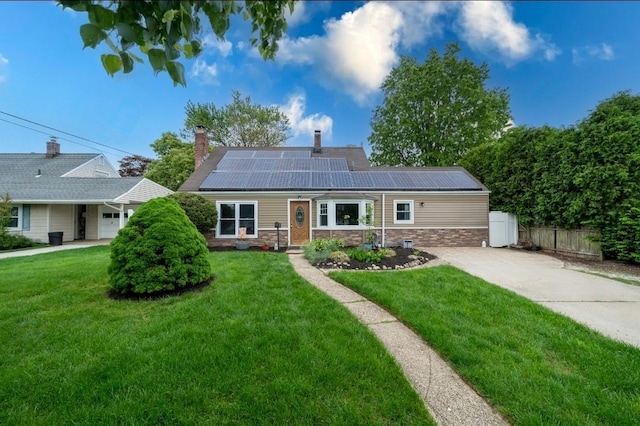33 Saddle Ln, Levittown, NY 11756 - single story home with roof mounted solar panels, a chimney, and concrete driveway
