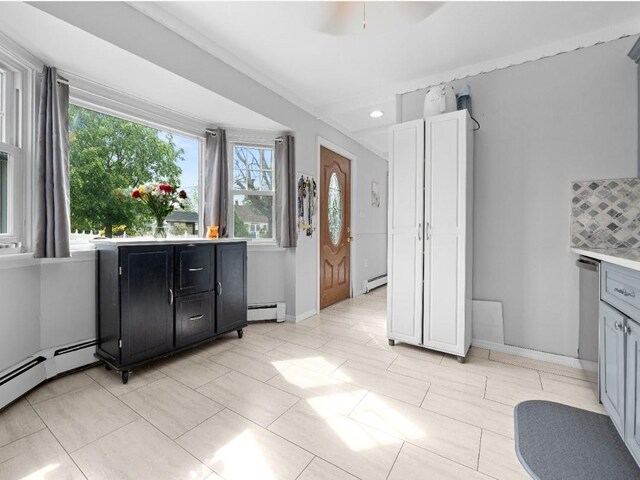 33 Saddle Ln, Levittown, NY 11756 - kitchen featuring baseboard heating, light countertops, dark cabinetry, baseboards, and recessed lighting