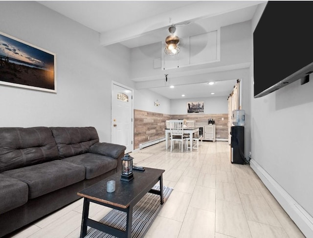 33 Saddle Ln, Levittown, NY 11756 - living room with baseboard heating, a wainscoted wall, and tile walls