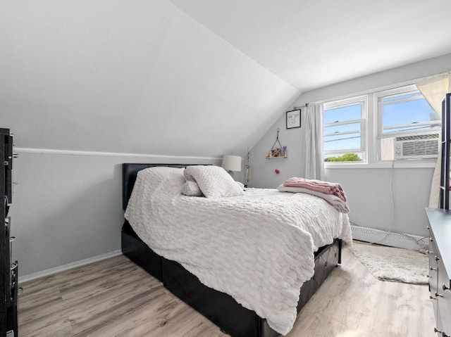 33 Saddle Ln, Levittown, NY 11756 - bedroom with a baseboard heating unit, wood finished floors, lofted ceiling, and baseboards