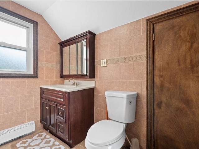 33 Saddle Ln, Levittown, NY 11756 - bathroom with a baseboard radiator, tile walls, toilet, lofted ceiling, and vanity