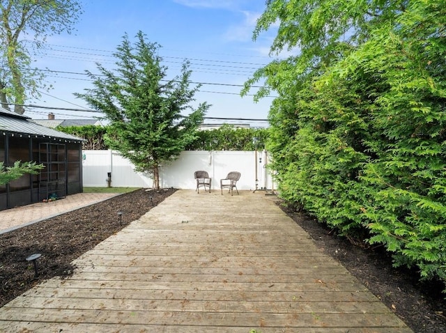 33 Saddle Ln, Levittown, NY 11756 - deck featuring a sunroom and a fenced backyard