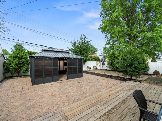 33 Saddle Ln, Levittown, NY 11756 - wooden deck with a fenced backyard, a sunroom, and a gazebo