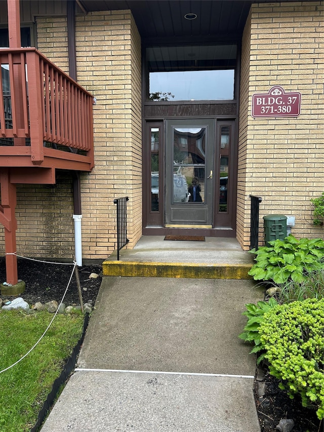 property entrance featuring brick siding