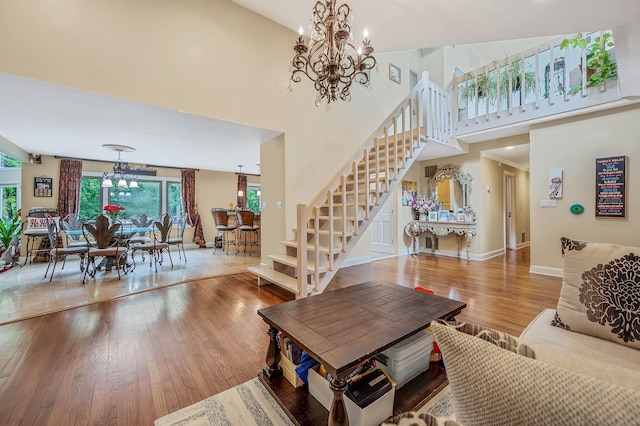 2 Farmview Dr, Dix Hills, NY 11746 - living room with a chandelier, stairway, wood finished floors, a towering ceiling, and baseboards